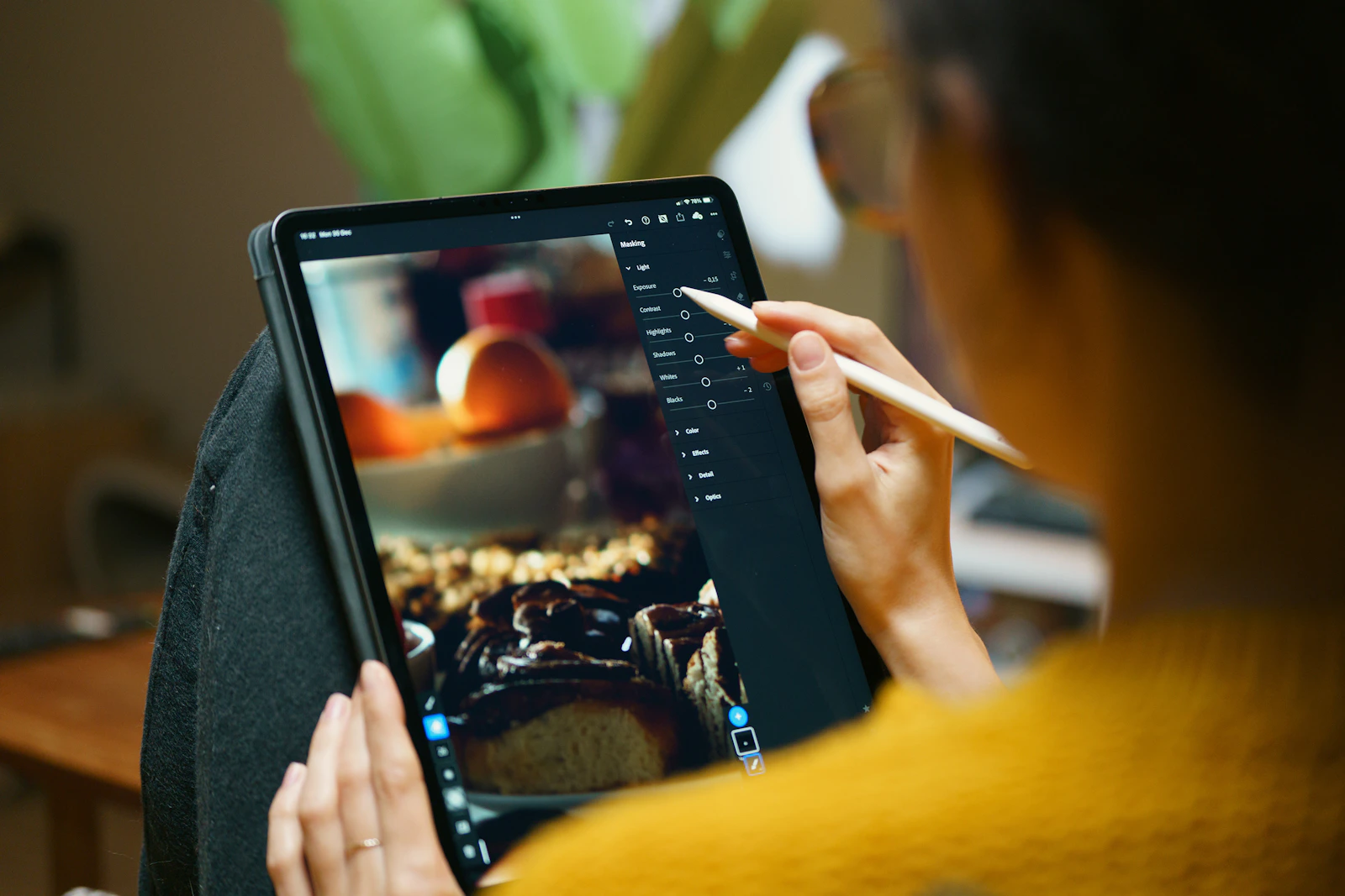 A person editing a photograph on a tablet with a stylus
