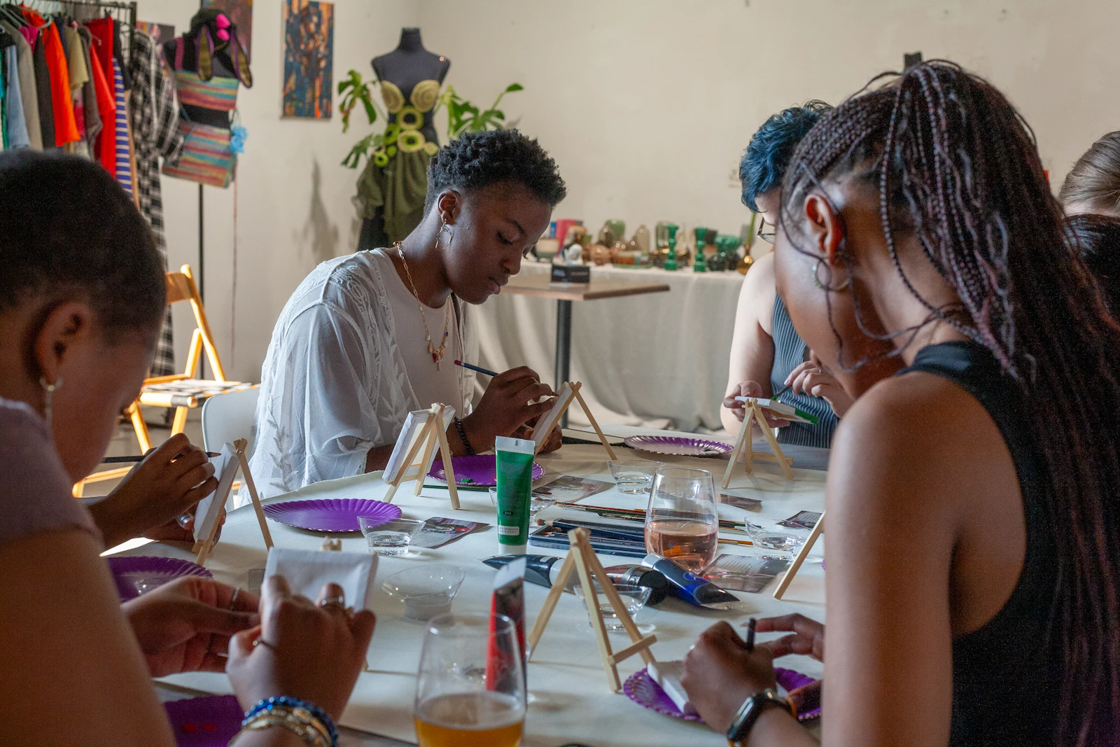 People painting together around a table in an art workshop