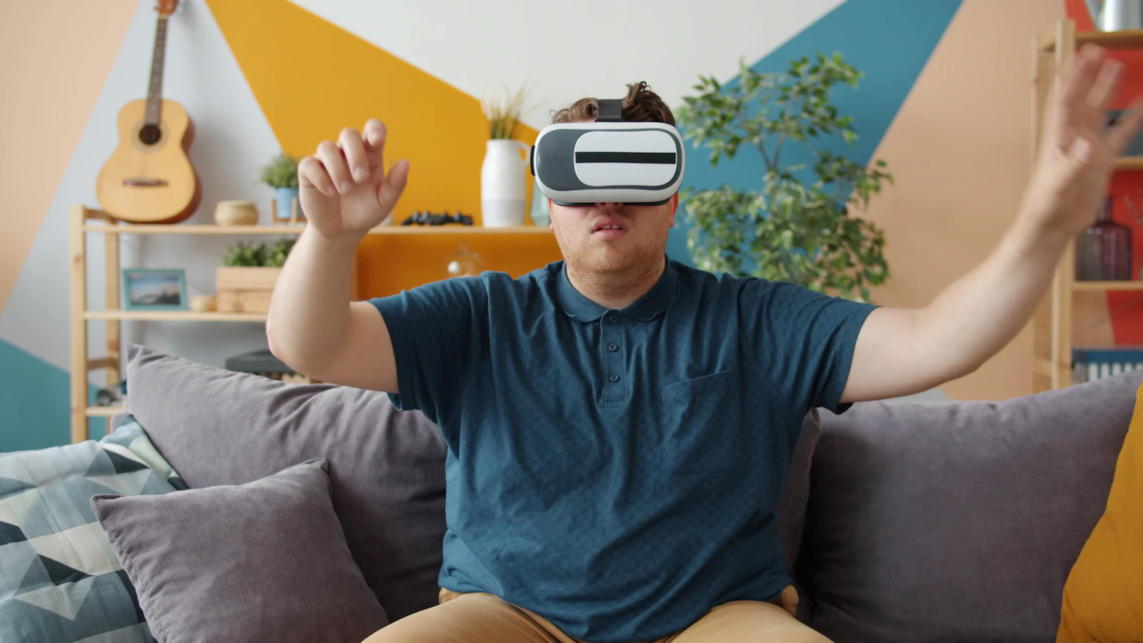 A person using a virtual reality headset and reaching out with both hands
